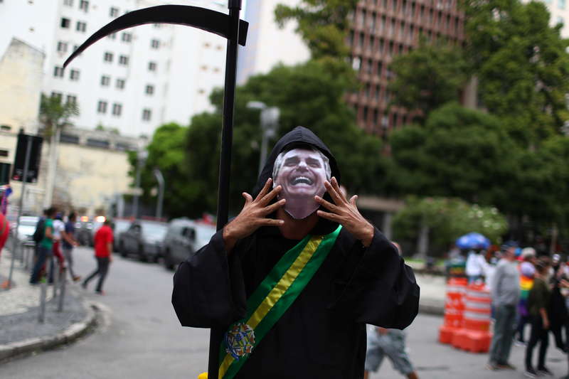 A person dressed up as the grim reaper attends a demonstration against Brazils President Jair Bolsonaros handling of the coronavirus disease (COVID-19) pandemic and to impeach him, in Rio de Janeiro, Brazil, June 19, 2021. REUTERS/Pilar Olivares